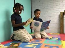 Two TES students reading books 